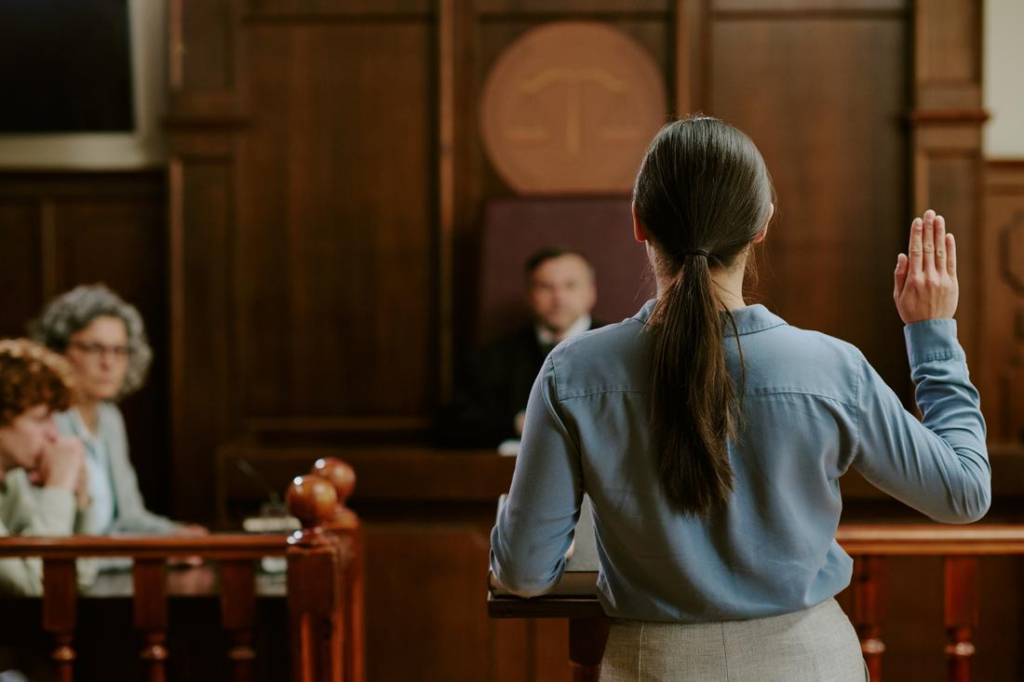 Witness testifying in courtroom with lawyers
