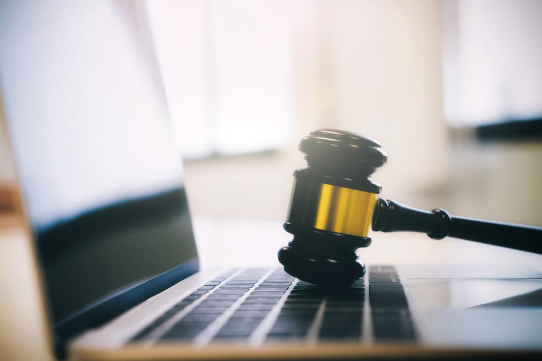 Gavel on laptop keyboard legal theme