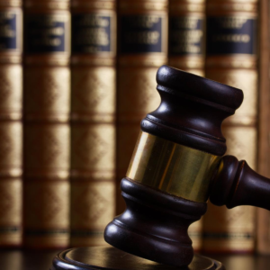 Law gavel on dark table with law books