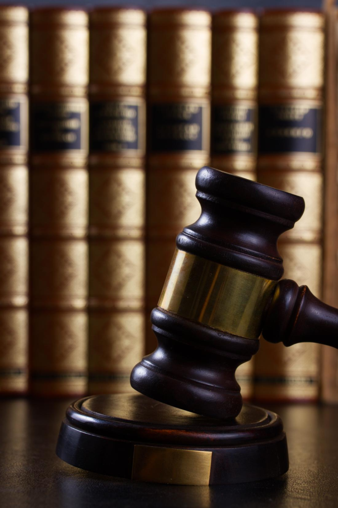 Law gavel on dark table with law books