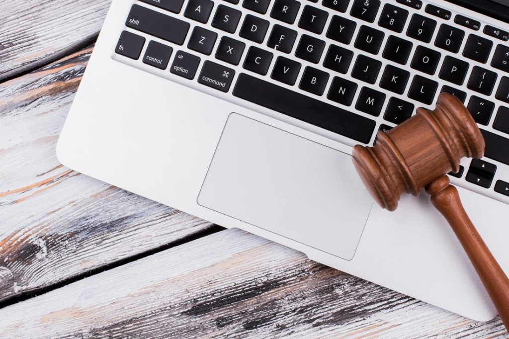 Wooden court gavel on laptop keyboard
